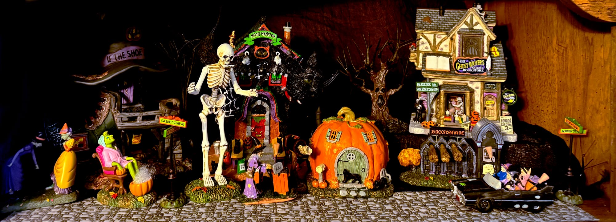 A&nbsp;level of Tina's Halloween village, featuring a row of colorful ceramic homes and townspeople.