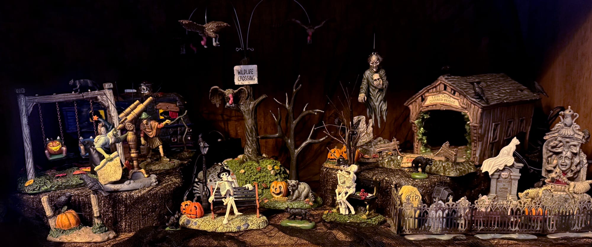 One of the levels of Tina's Halloween village, featuring a cute little street scene with skeletons and gravestones and pumpkins on a swingset.