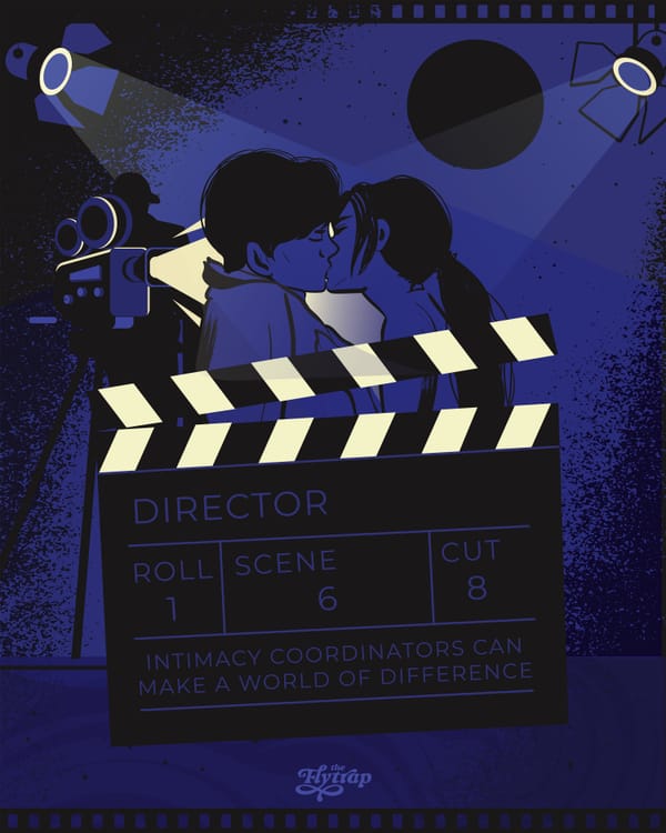 Two people kiss behind a film slate.